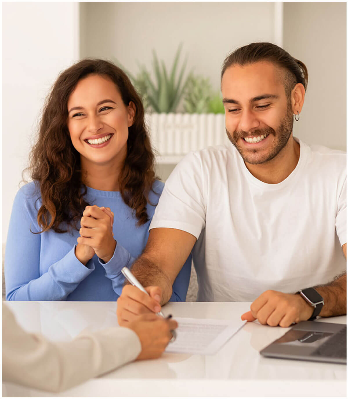 Happy couple signing papers